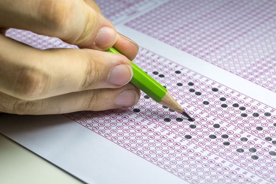 AP exam scantron paper with pencil drawing selected choice on answer sheets at school