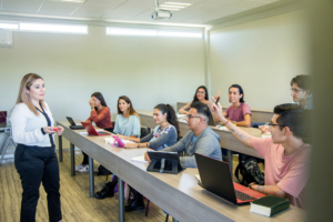 female professor teaching a small class of college students