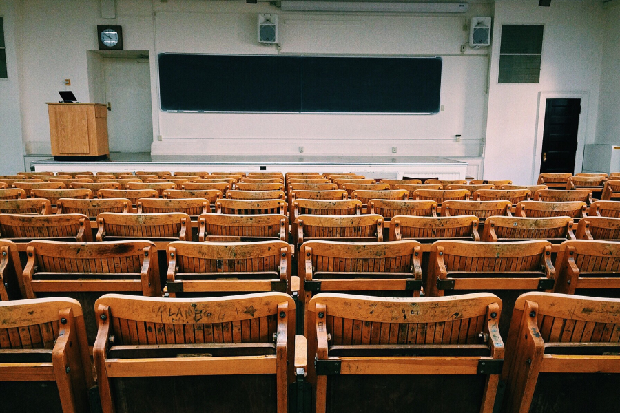 College lecture hall with empty seats facing the front of the classroom